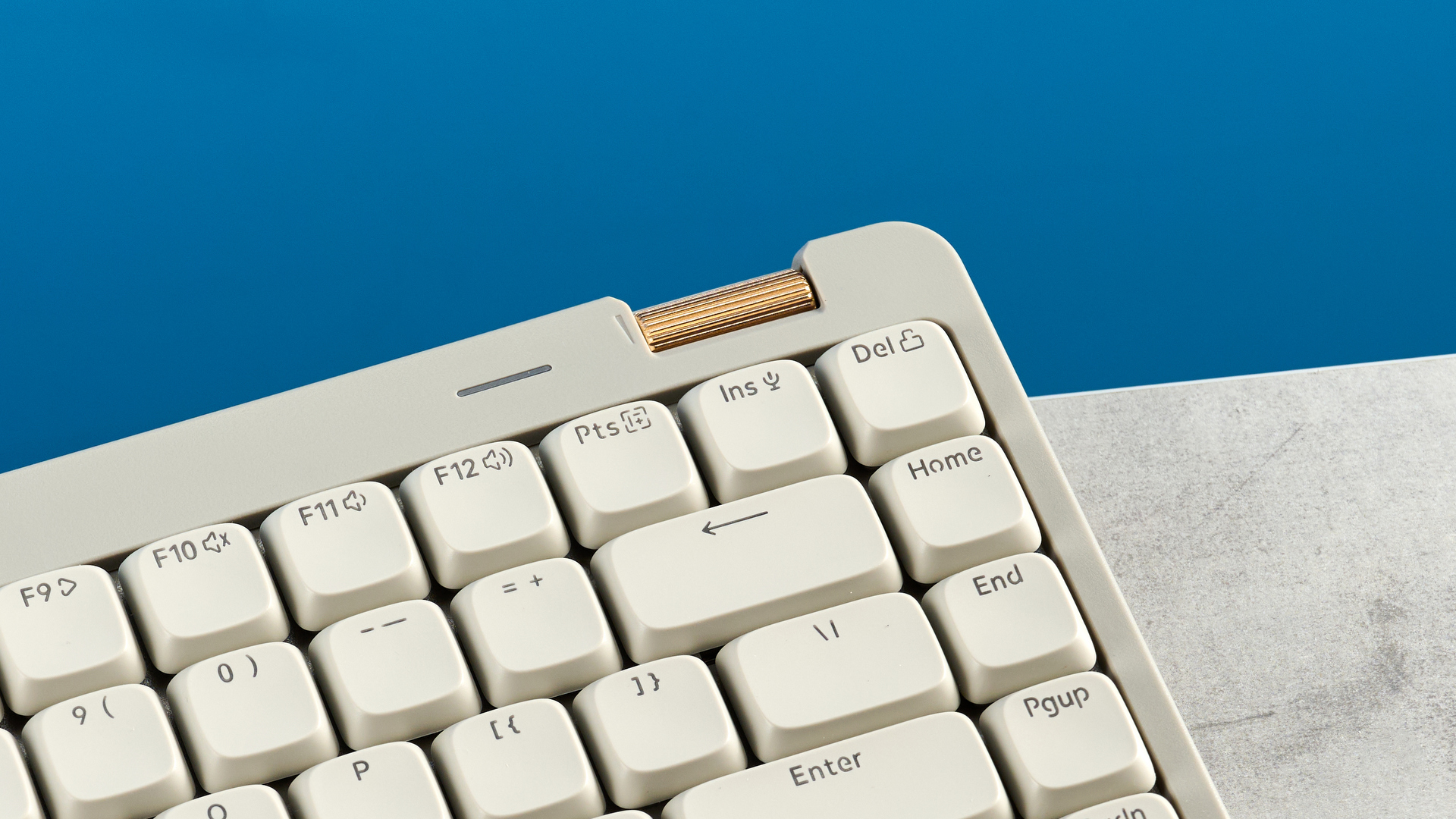 The Lofree Flow Lite84 on a stone surface against a blue background
