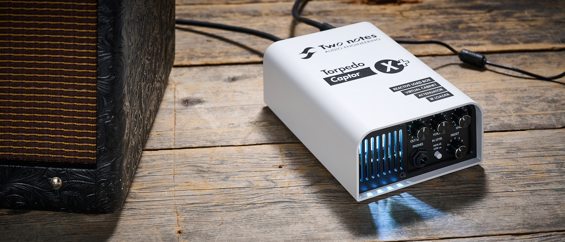 A Two Notes Torpedo Captor X Plus reactive load box next to a Fender tube amp