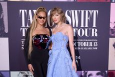 Beyonce and Taylor Swift pose together at the premiere of Swift's "Eras Tour" concert movie. 