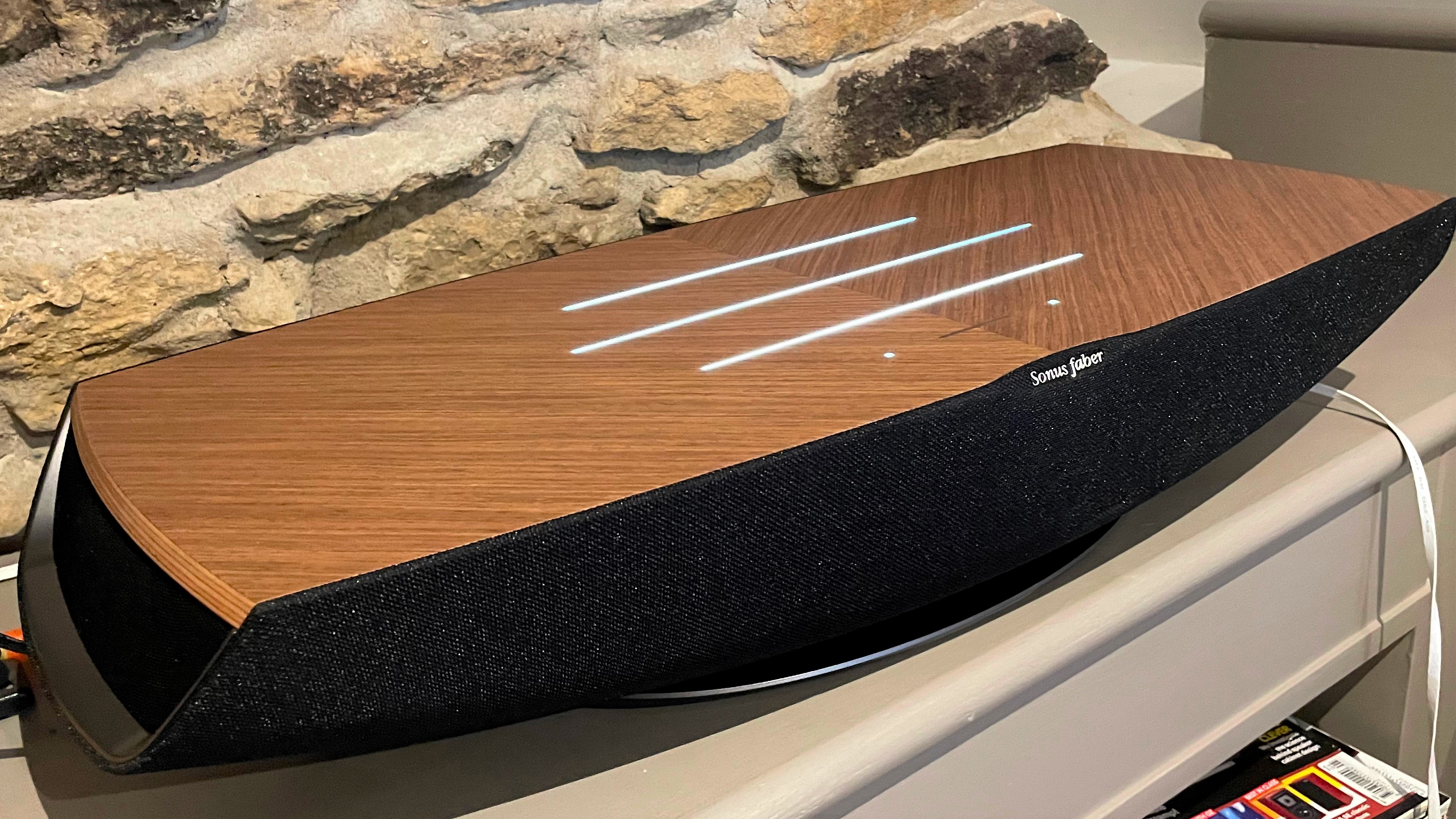 Sonos faber Omnia on a shelf in front of stone wall