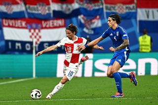 Croatia's midfielder #10 Luka Modric and Italy's defender #05 Riccardo Calafiori fight for the ball during the UEFA Euro 2024 Group B football match between Croatia and Italy at the Leipzig Stadium in Leipzig on June 24, 2024