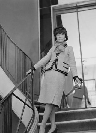 Coco Chanel wearing her classic Chanel suit