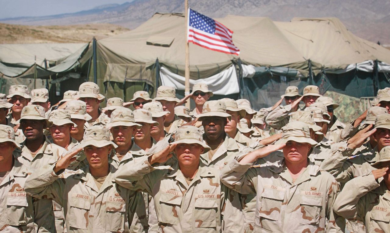 A detachment of the 82nd Airborne Division stands at attention before a U.S. flag in Orgun-e, Afghanistan.