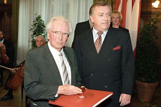 Victor Frankl being awarded honorary citizenship in a government building with other men and women in suits around him