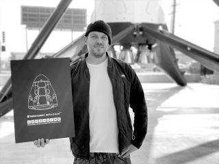 Artist Tristan Eaton with his "Human Kind" limited edition box set at SpaceX's headquarters in Hawthorne, California.