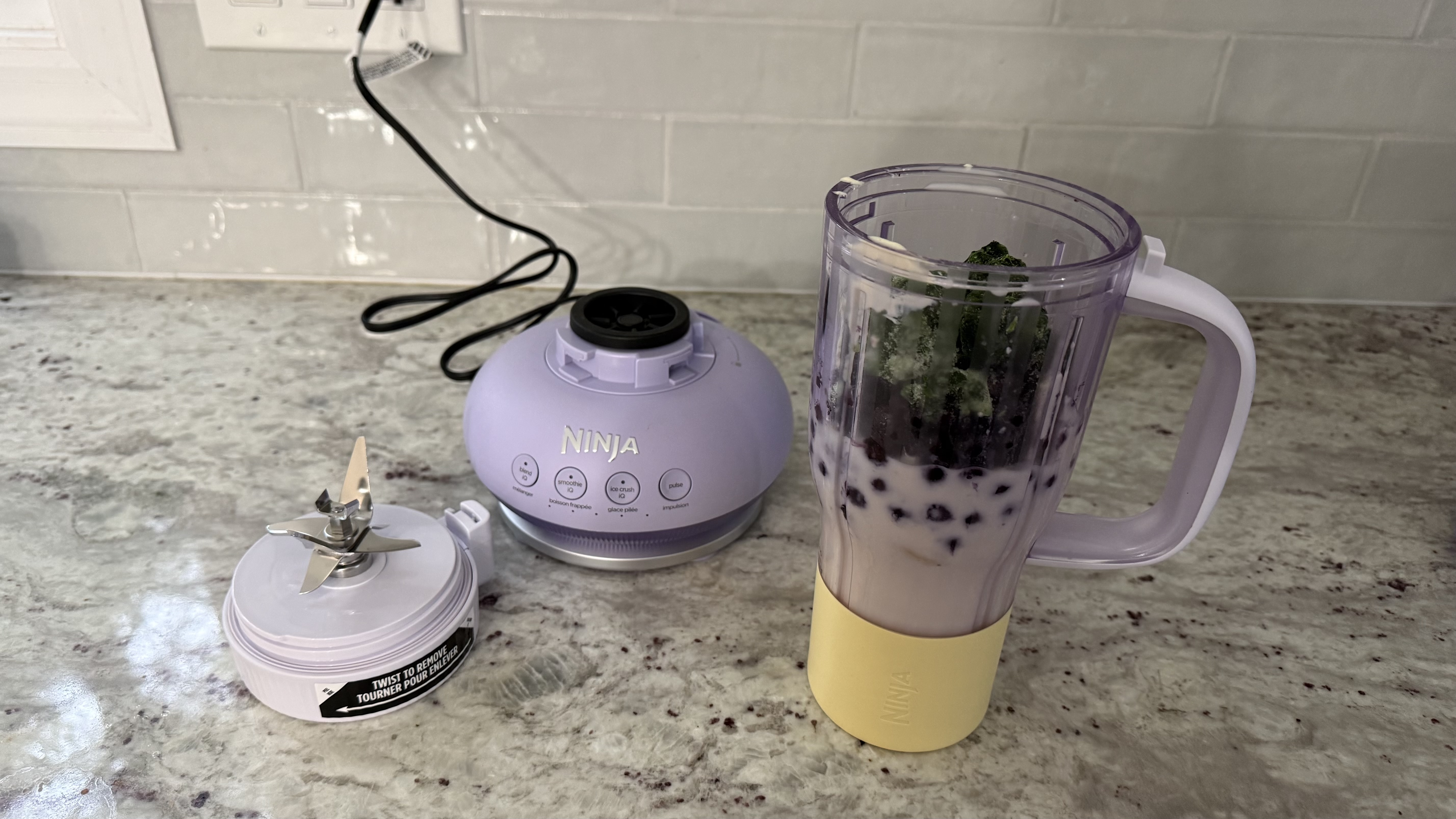 Ninja BlendBOSS&trade; Tumbler Blender with 26oz Travel Tumbler making banana, blueberry, and spinach smoothie