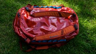 A large Gregory Alpaca 60 duffel bag on a patch of grass.