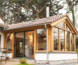 Oak frame conservatory with solid tiled roof