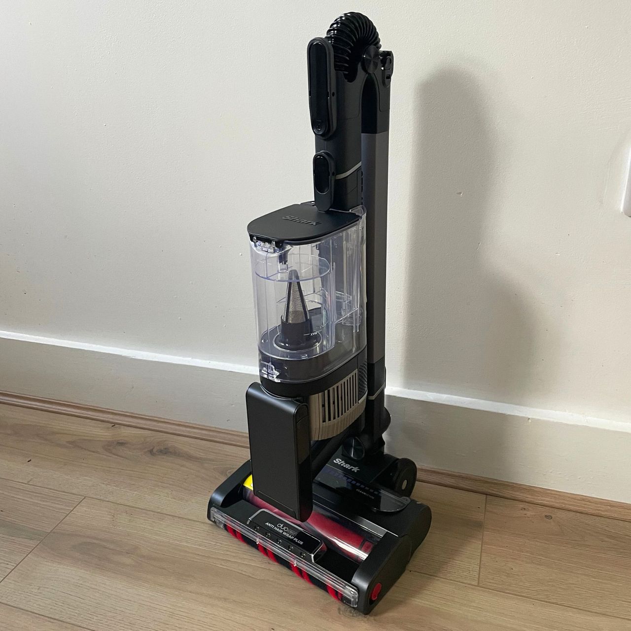 Shark Stratos Cordless Vacuum folded up in front of a white wall