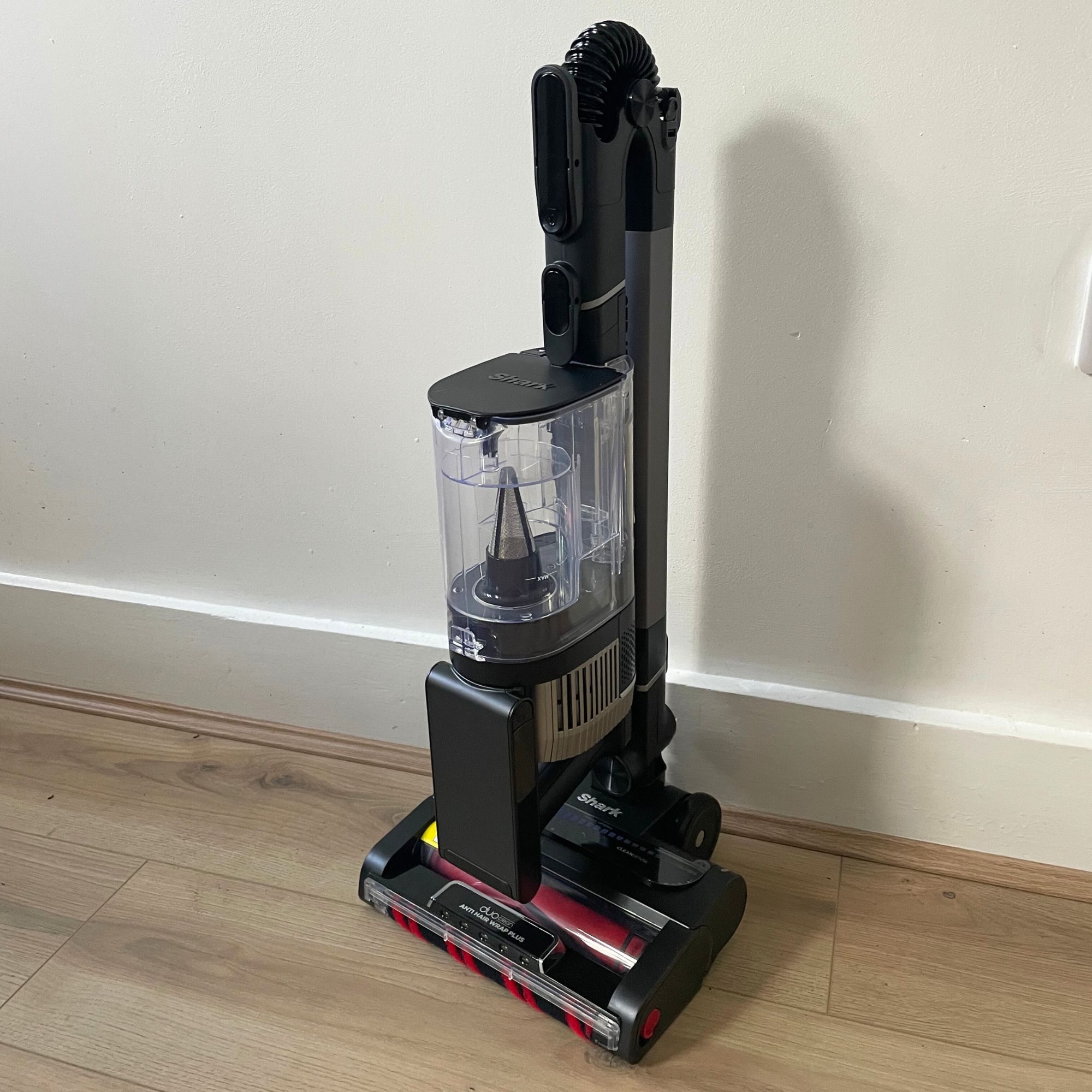 Shark Stratos Cordless Vacuum folded up in front of a white wall