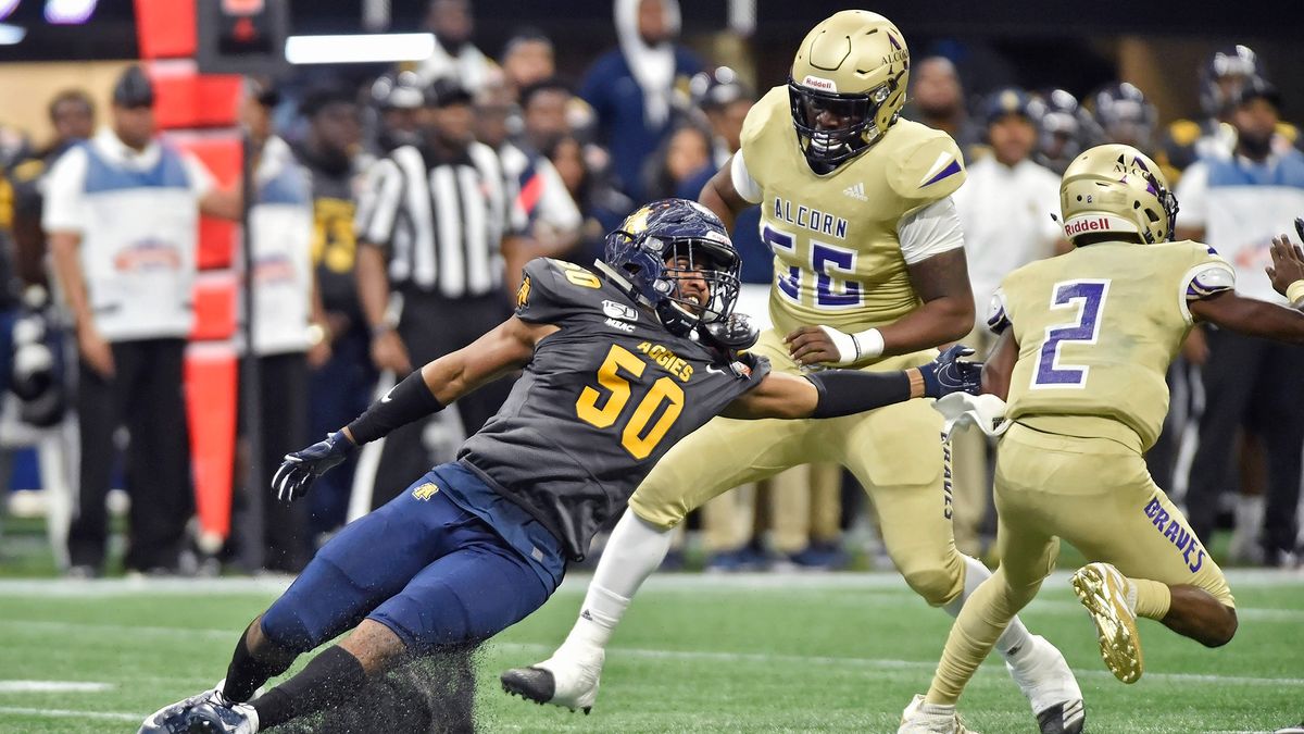 North Carolina A&amp;T defensive end Devin Harrell (50) reaches for the Alcorn State quarterback during the first quarter of an NCAA college football game in the Celebration Bowl on December 21, 2019, at Mercedes-Benz Stadium.