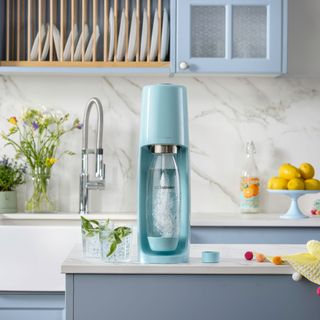 kitchen with white wall white and blue countertop and blue sodastream