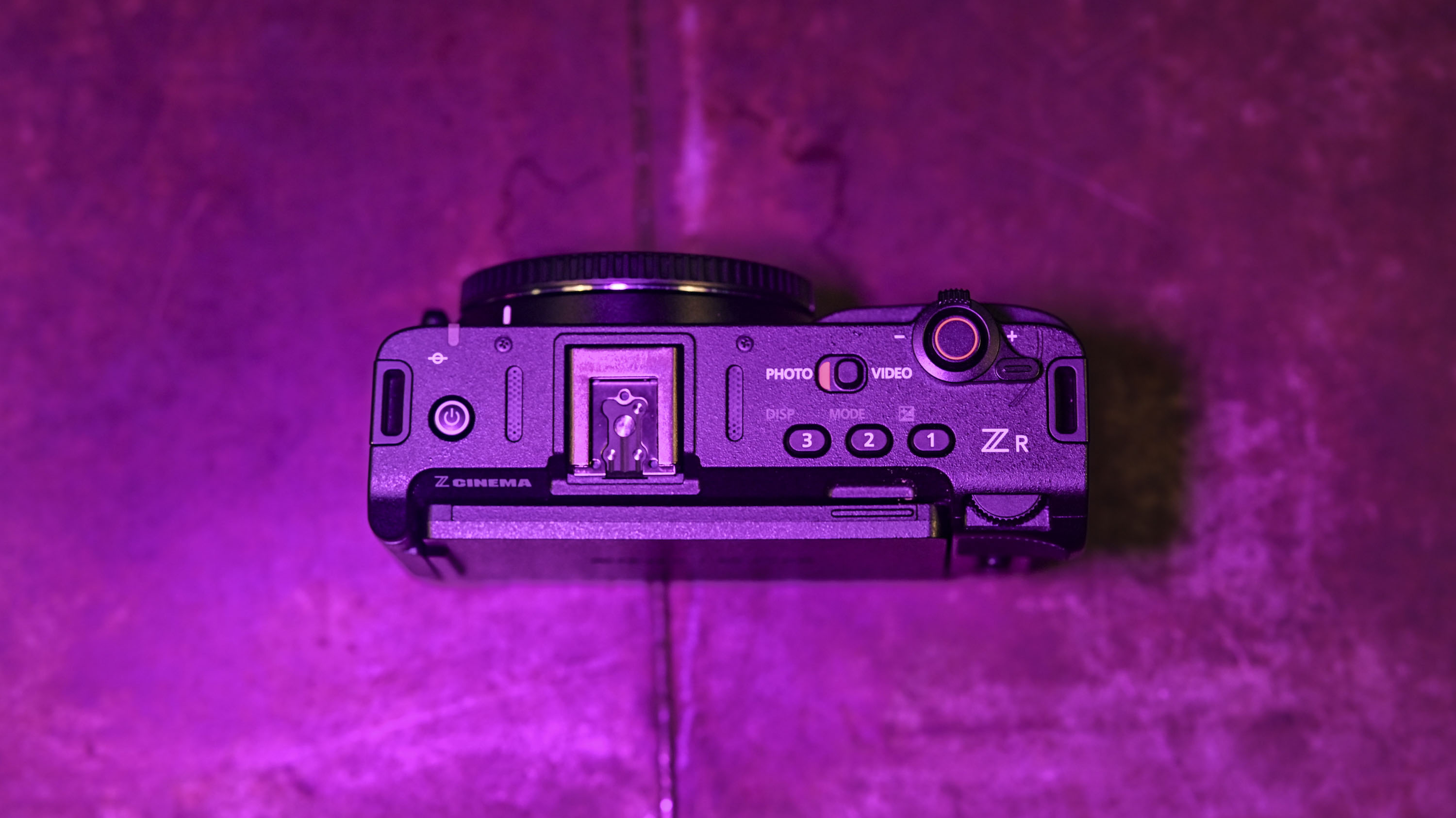 Top of the Nikon ZR camera under low key magenta lighting