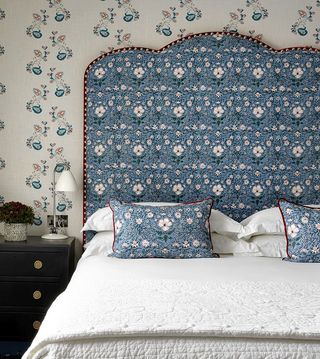 Bedroom with blue headboard on bed by Kit Kemp