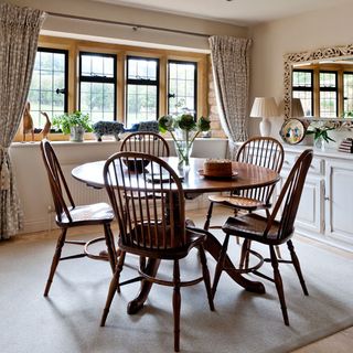kitchen dining area with wooden dining table and chairs