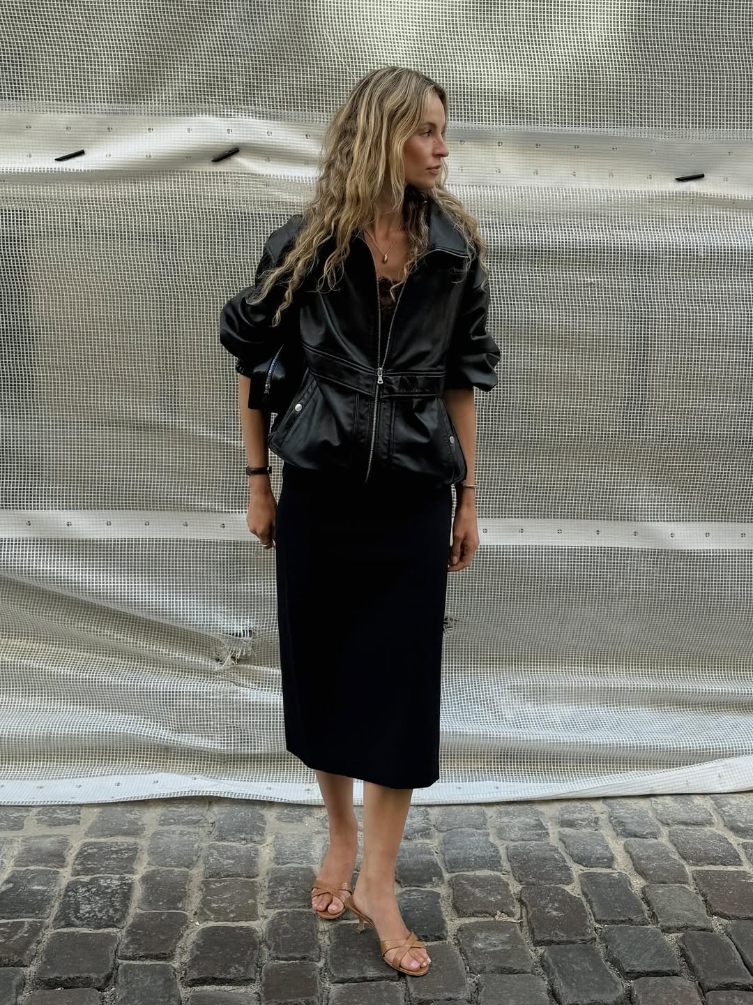 Anouk in a leather jacket and black pencil skirt