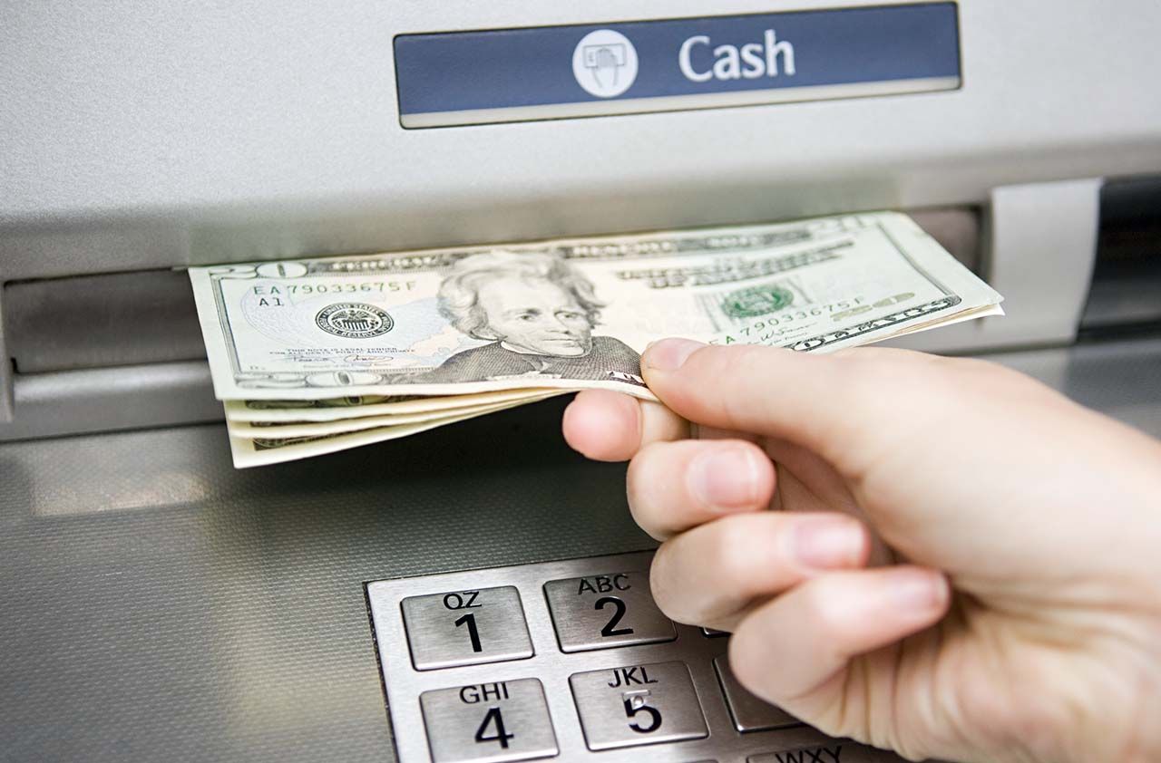 Person taking money out of an ATM