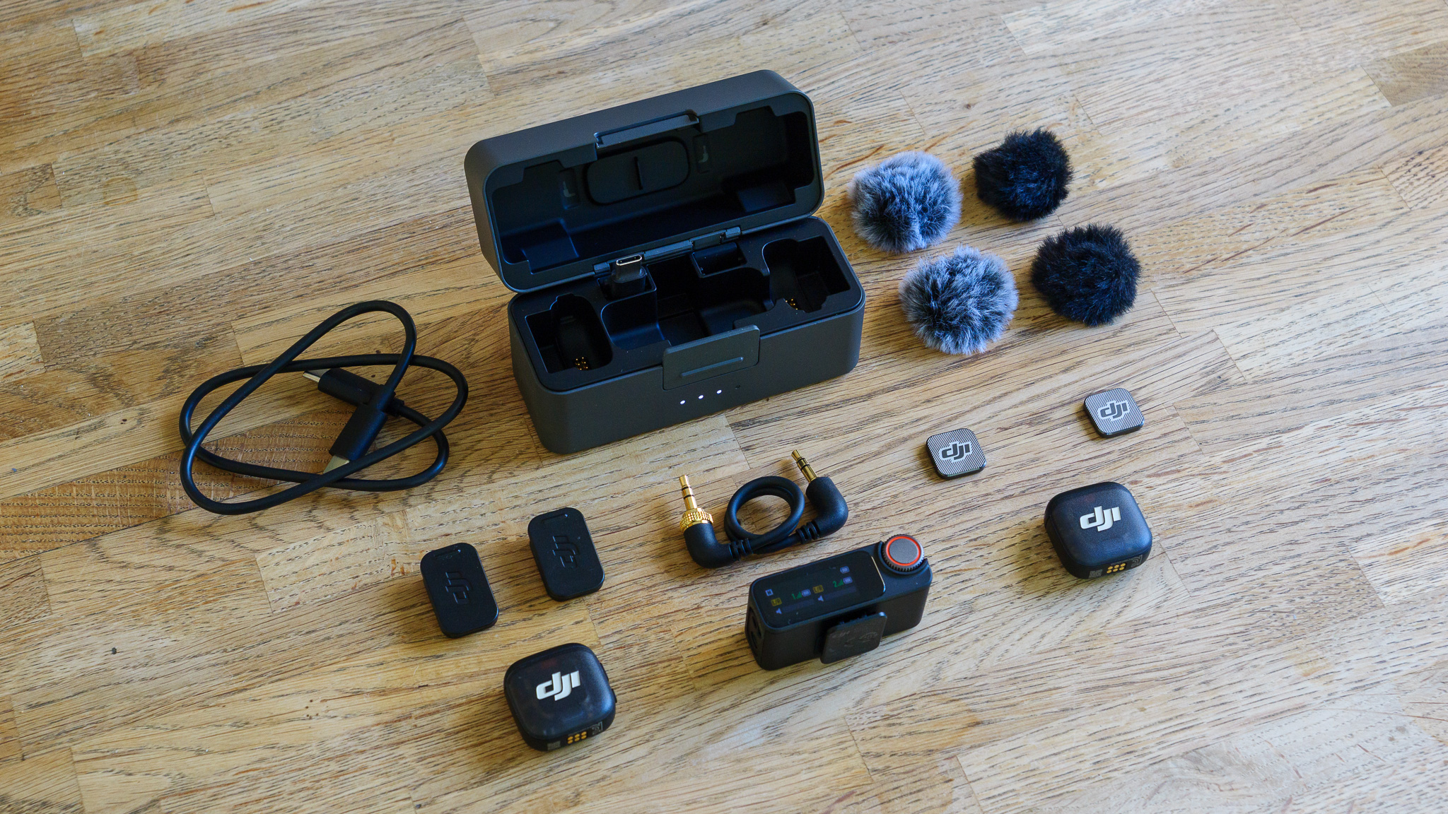 DJI Mic 3 wireless microphone bundle on wooden table