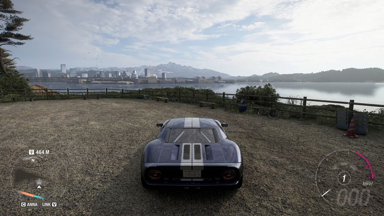 Forza Horizon 6 Treasure Cars: A player parked in a Ford GT on a coastal path overlooking Tokyo City in the distance.