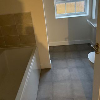 bathroom with bathtub and window