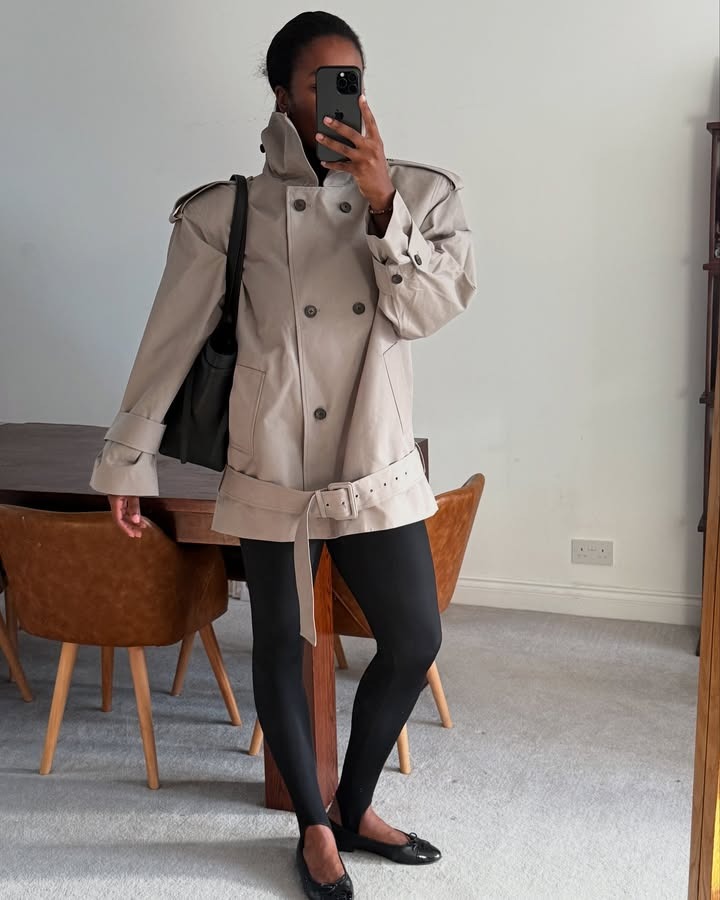 @nlmarilyn wearing a cropped trench coat with stirrup leggings with flats.