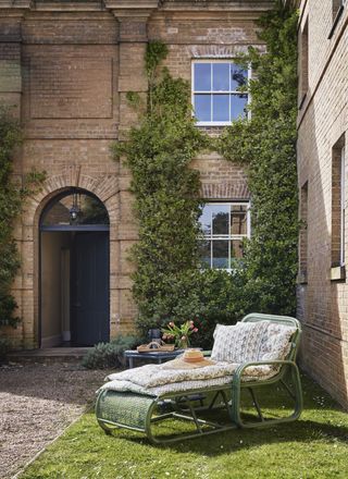 Stone house with sun lounger with upholstered cushions
