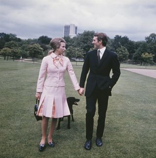 Princess Anne with her fiancé, equestrian champion Mark Phillips in the grounds of Buckingham Palace in London, following the announcement of their engagement the previous day, UK, 30th May 1973.