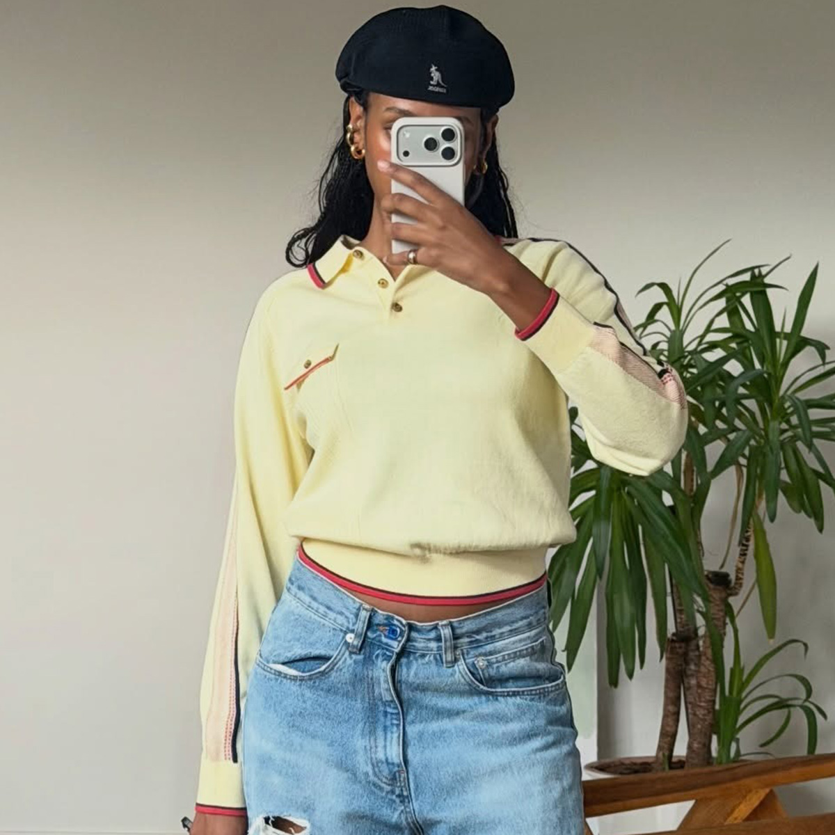 Claire wears a yellow polo knit.