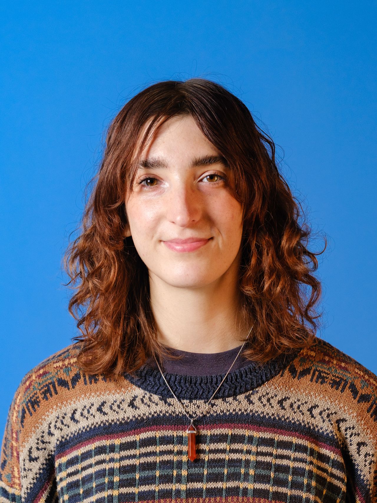 A photo of a woman against a blue background.