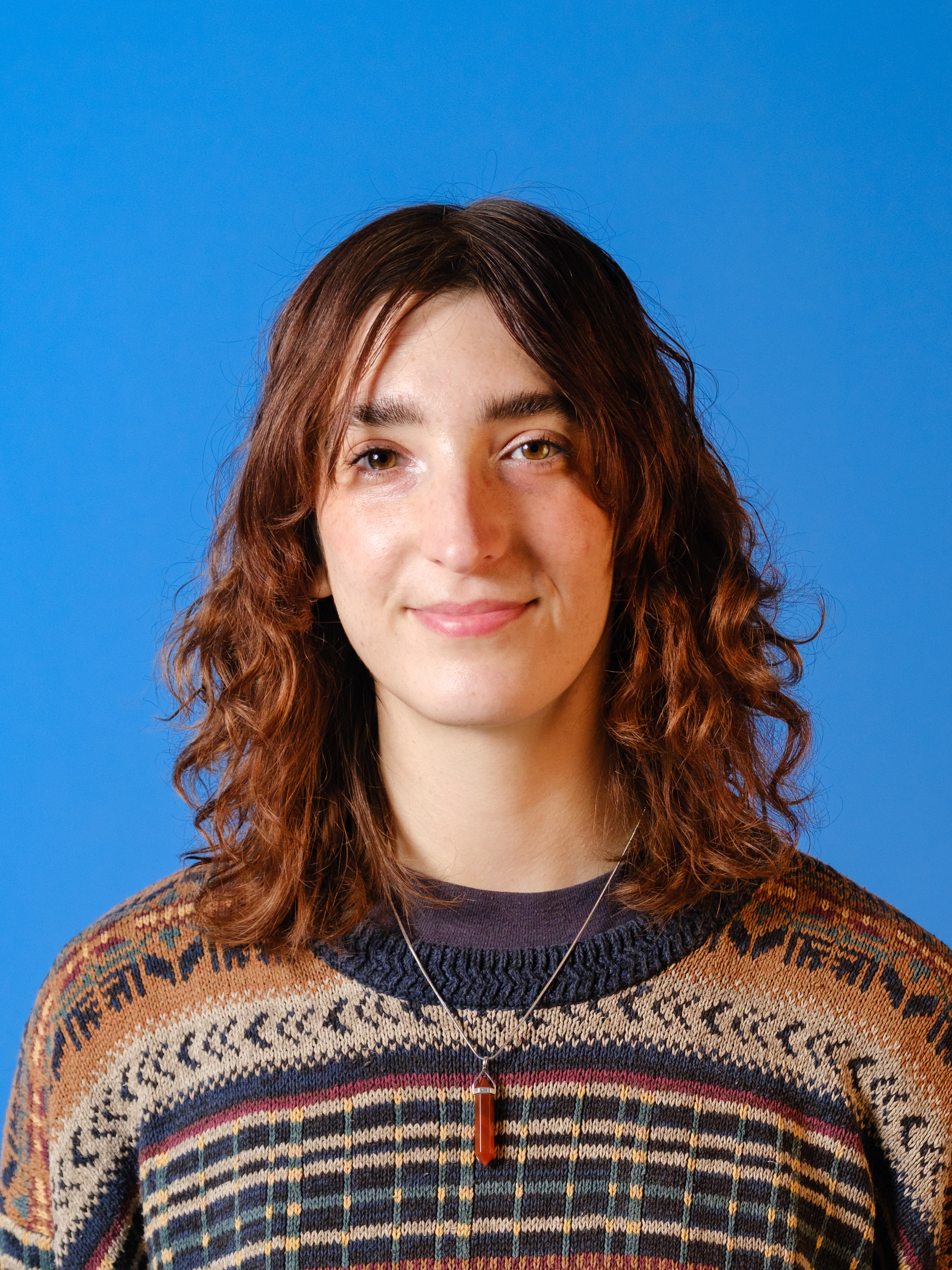 A photo of a woman against a blue background.