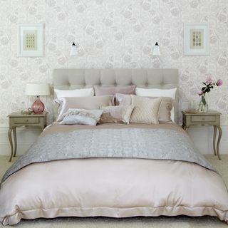 bedroom with headboard and rose pastel wall