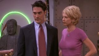 Thomas Gibson and Jenna Elfman standing together with looks of concern in Dharma and Greg.
