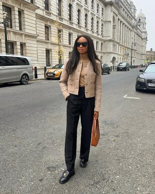 fashion influencer @symphonyofsilk wearing a cropped jacket with black trousers in London