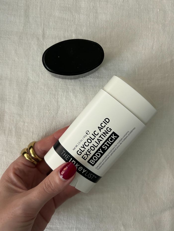 Junior beauty editor Grace Lindsay holding The INKEY List Glycolic Acid Exfoliating Body Stick
