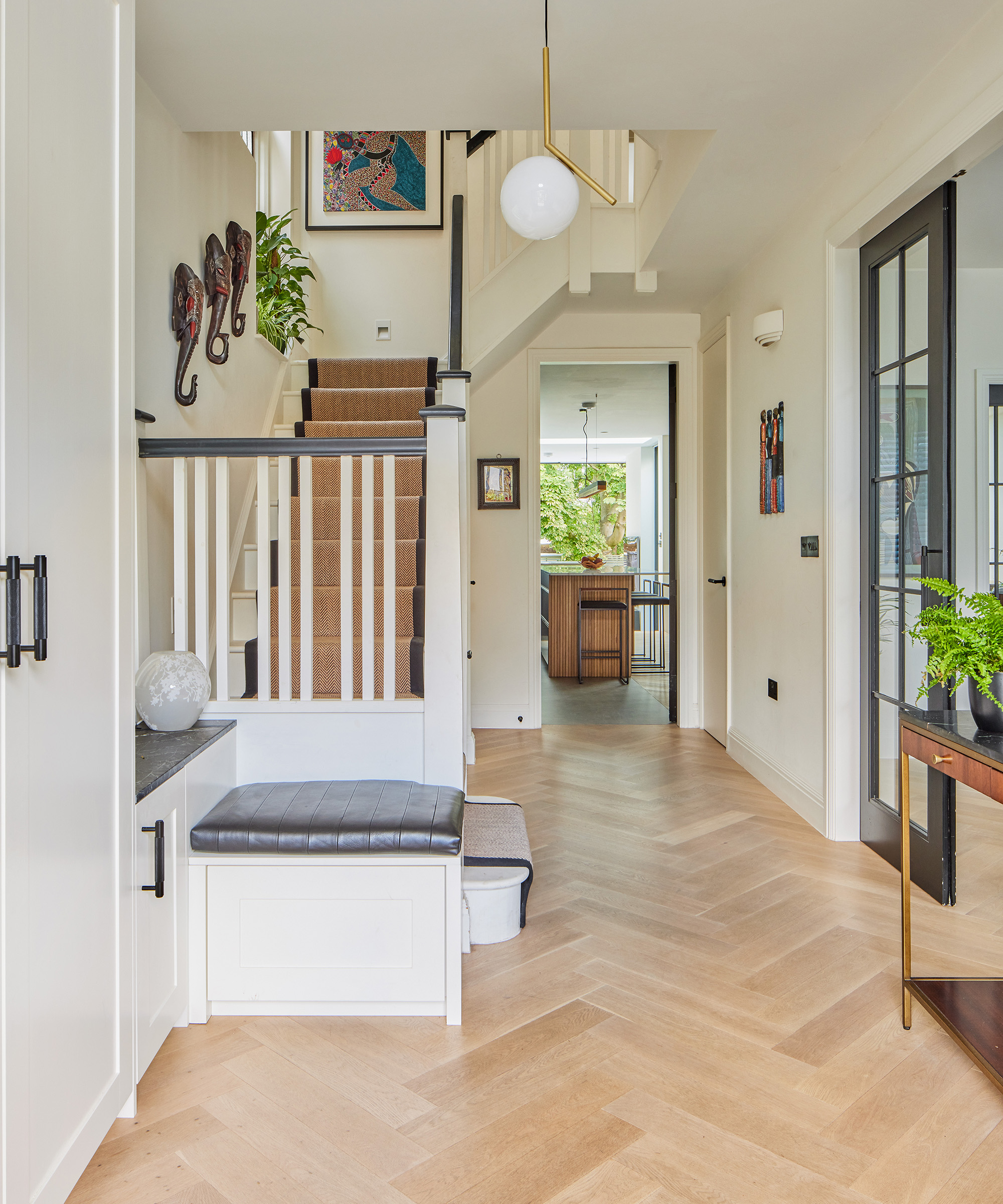 inside a bright and airy hallway with light oak flooring and new staircase