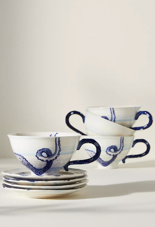 teacups and saucers with a sea life print stacked on top of each other