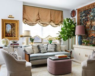 decorative living room with scalloped blinds and large wall hanging