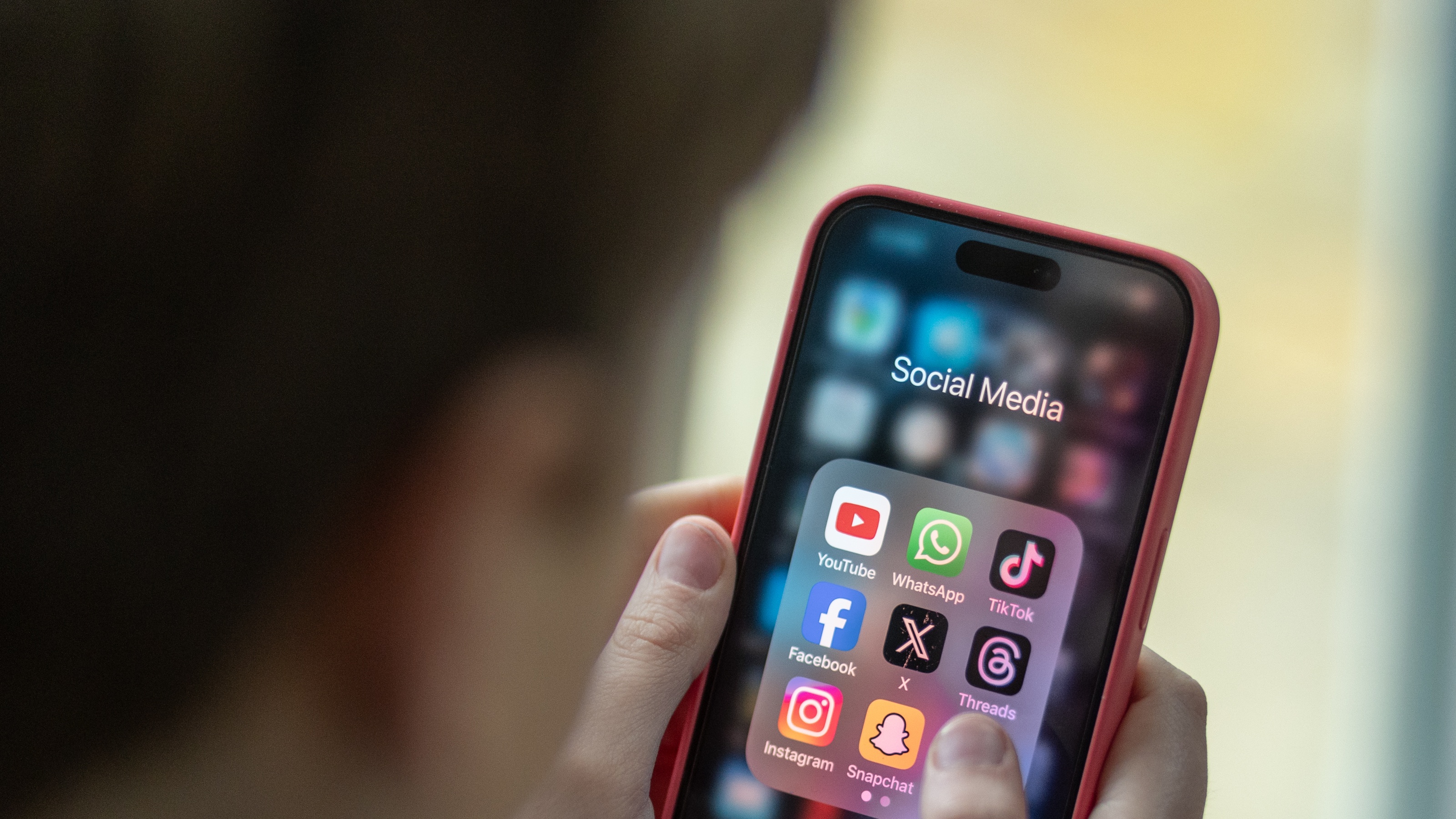 Man on smart phone looking at social networking apps (Photo by Matt Cardy/Getty Images)