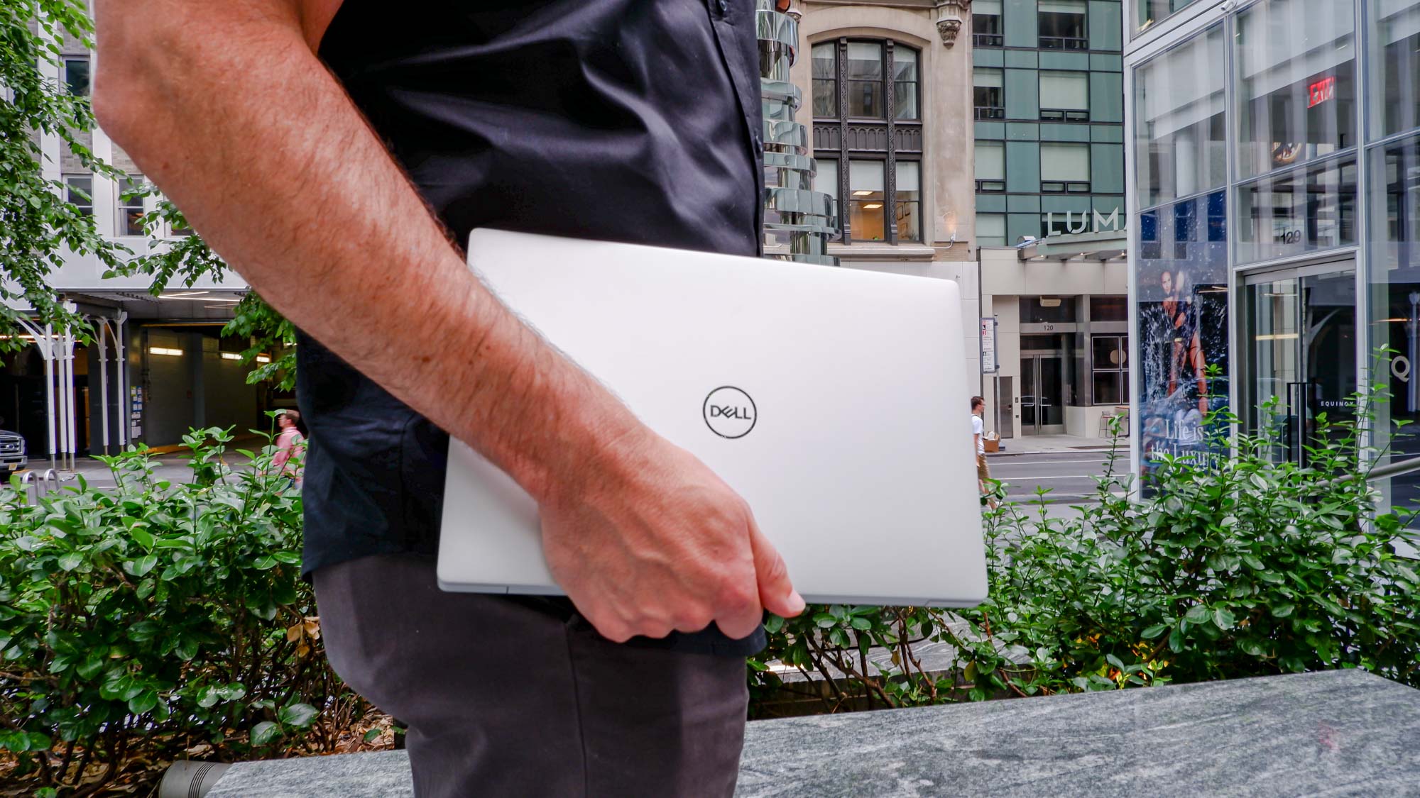 Man holding Dell XPS 13 Plus laptop