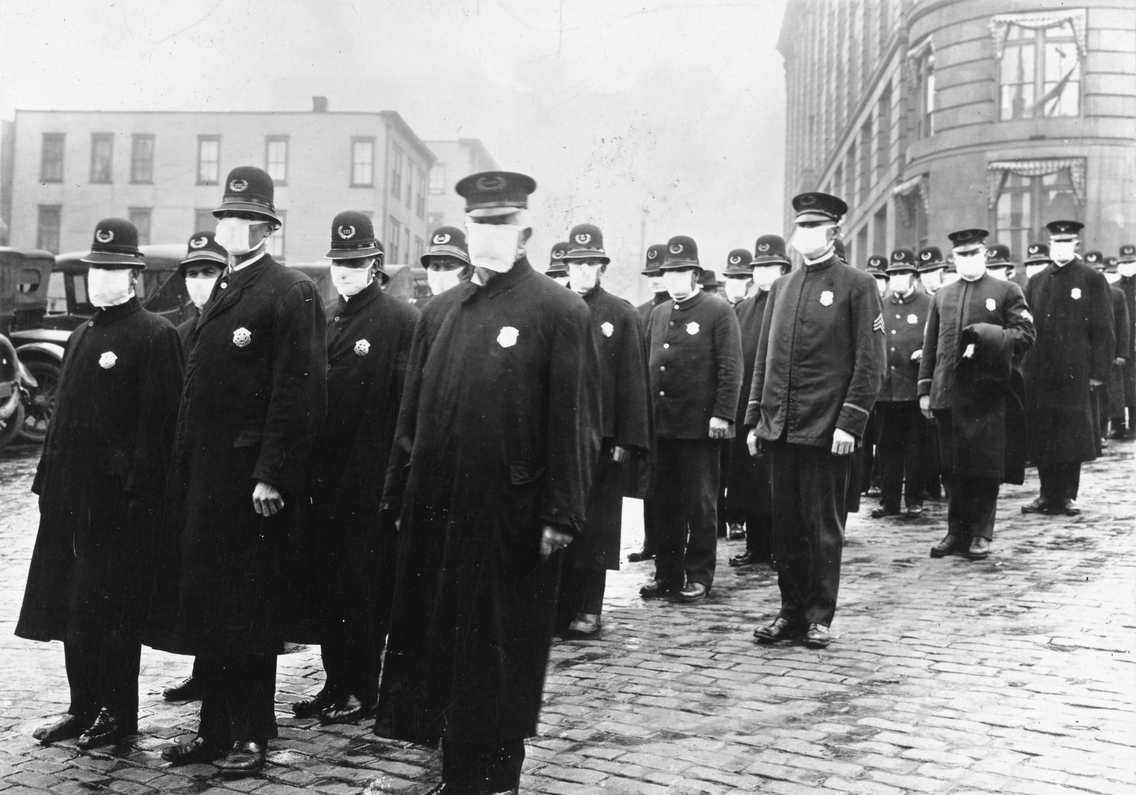 Policemen in Seattle wearing masks made by the Red Cross, during the influenza epidemic. December 1918.