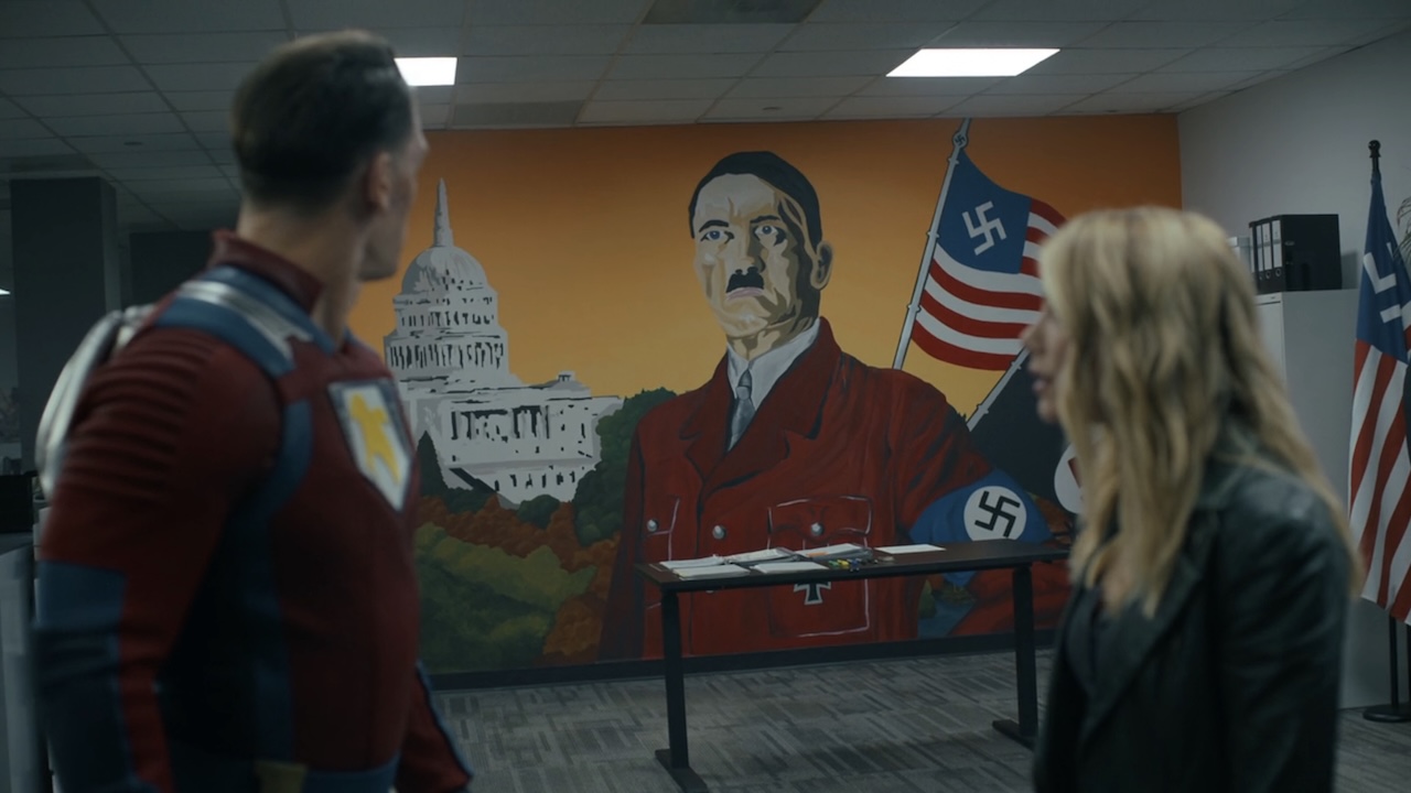 Chris Smith and Emilia Harcourt looking at Earth-X's Hitler mural in Peacemaker Season 2