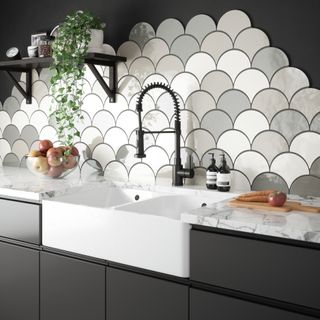 black kitchen with scalloped shaped splash back in white and shades of grey