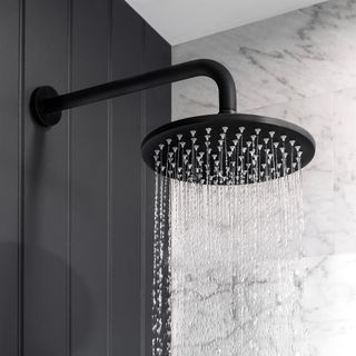 Matte black shower head with running water