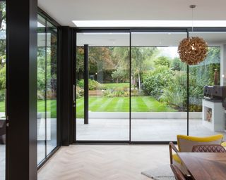 Multiple sets of IDSystems sliding doors connect a house and garden