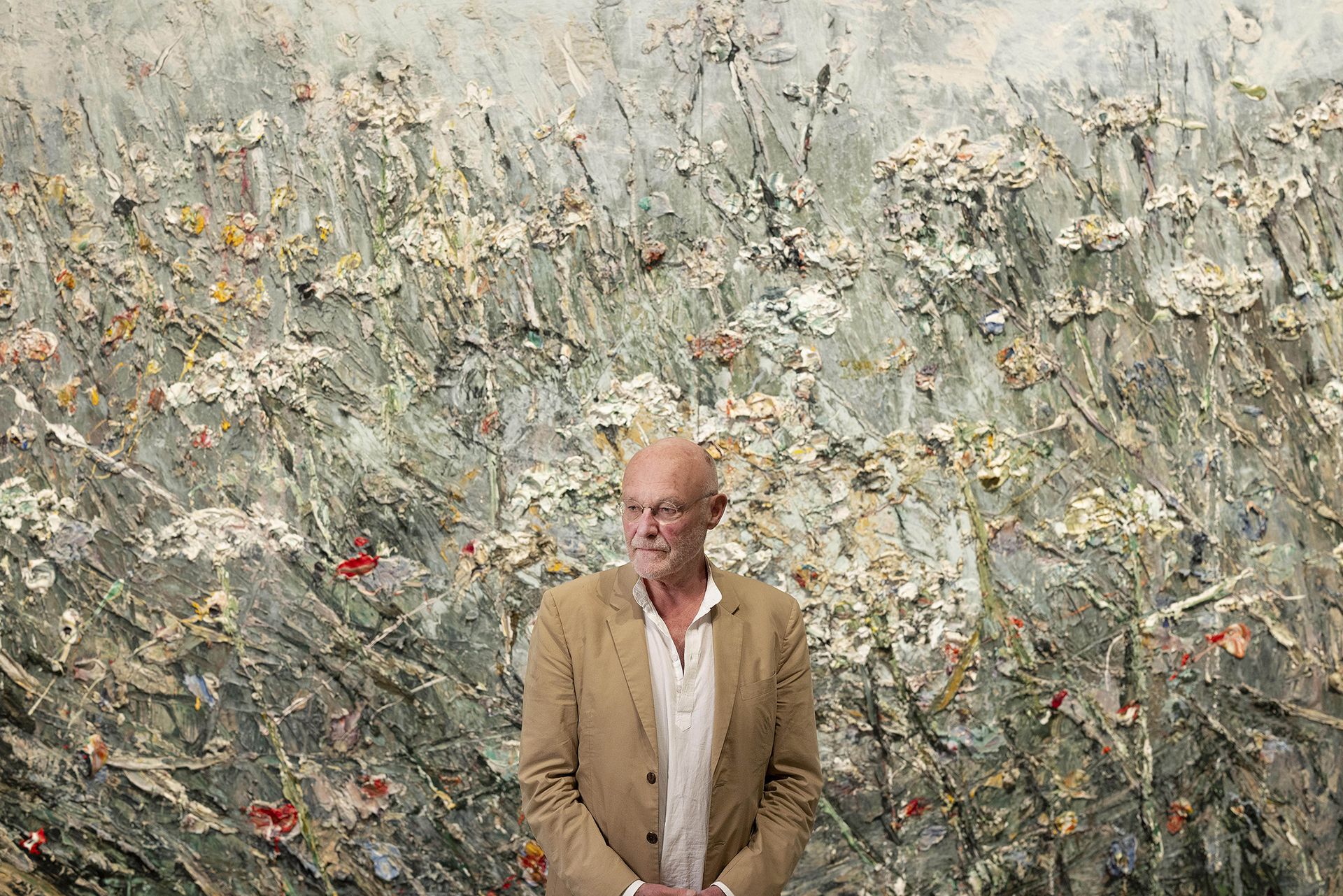 artist in front of artwork