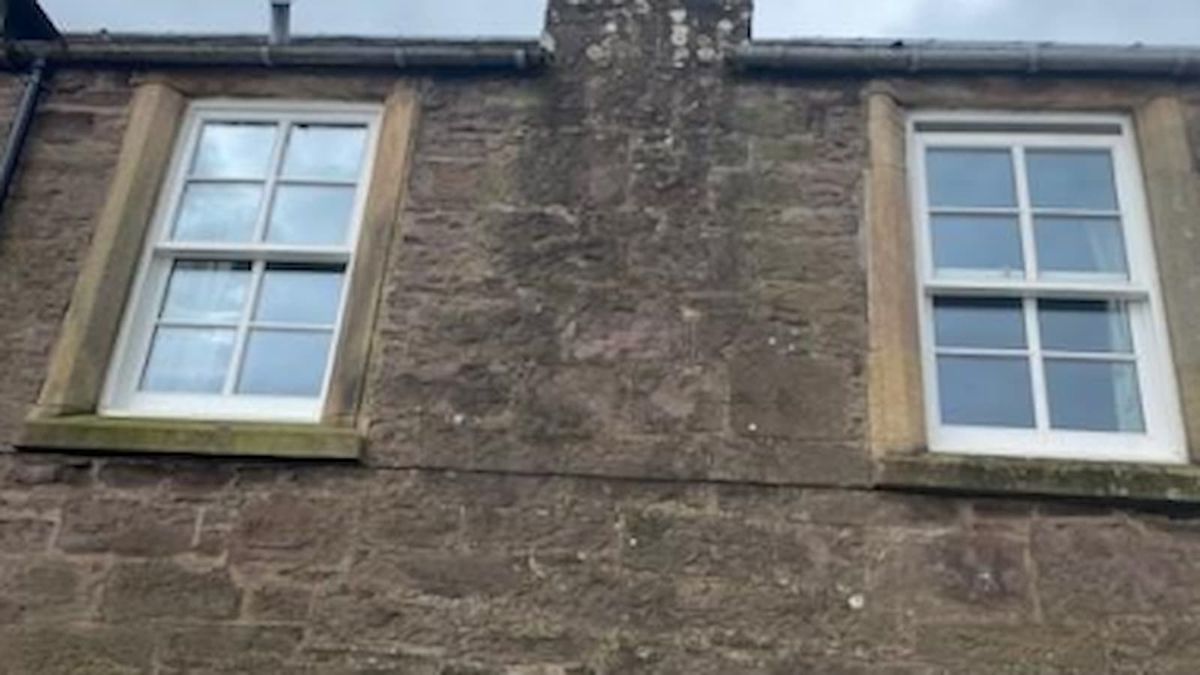 A pair of upstairs sash windows replaced with new timber frames