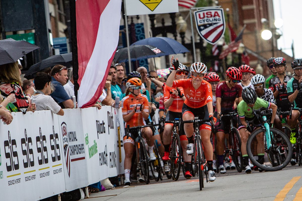 Emma White waves to the crowd during call-ups at the US Pro Criterium