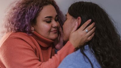 Tender embrace between a same-sex couple - stock photo