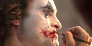 Joaquin Phoenix puts on makeup in Joker