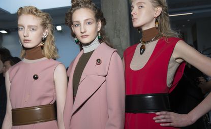 three female models wearing pink and red